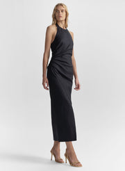 Woman wearing a dark blue sleeveless dress on a white background