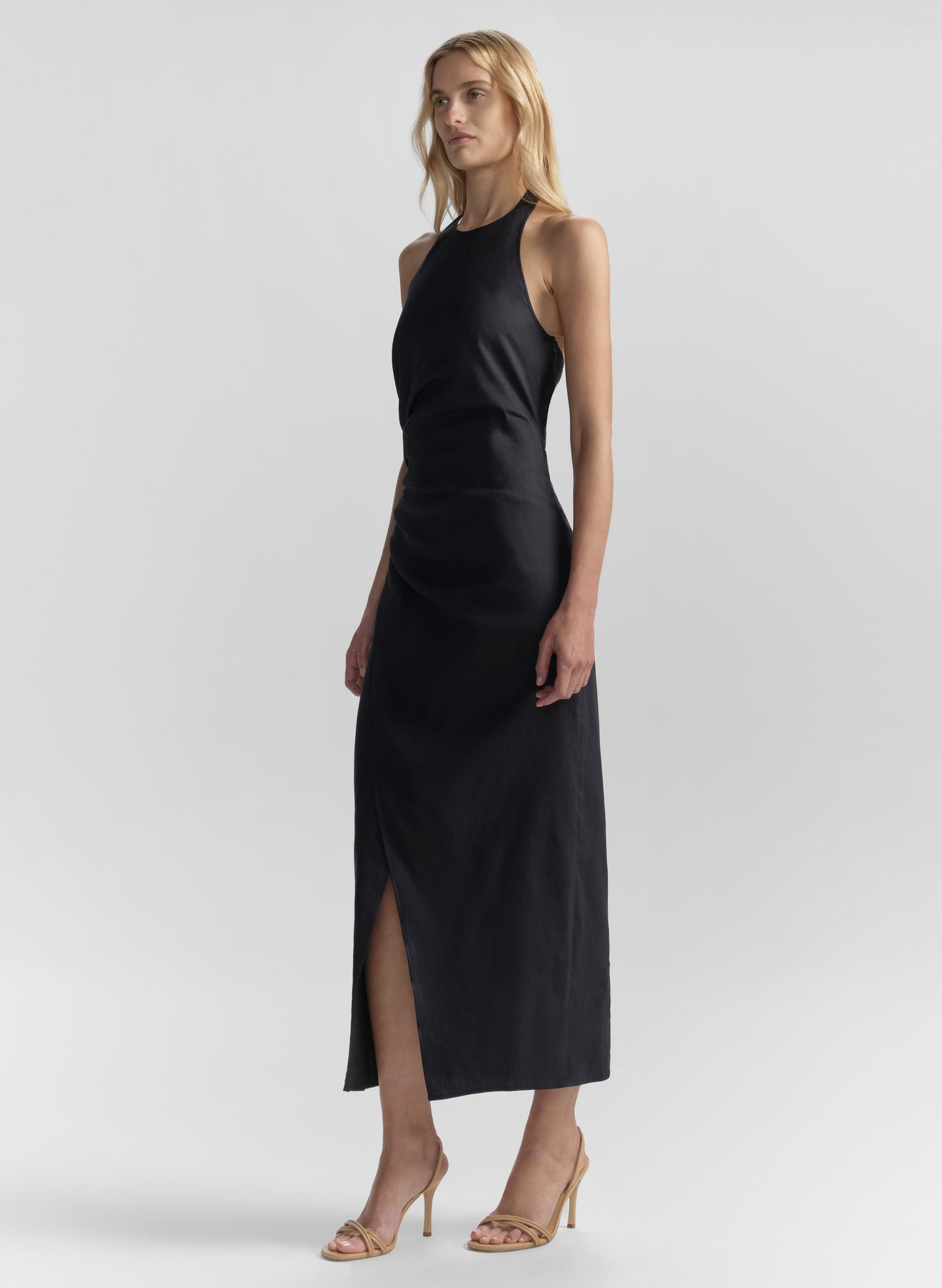 Woman wearing a blue sleeveless dress on a white background