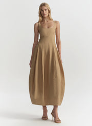 Woman wearing a beige dress on a white background