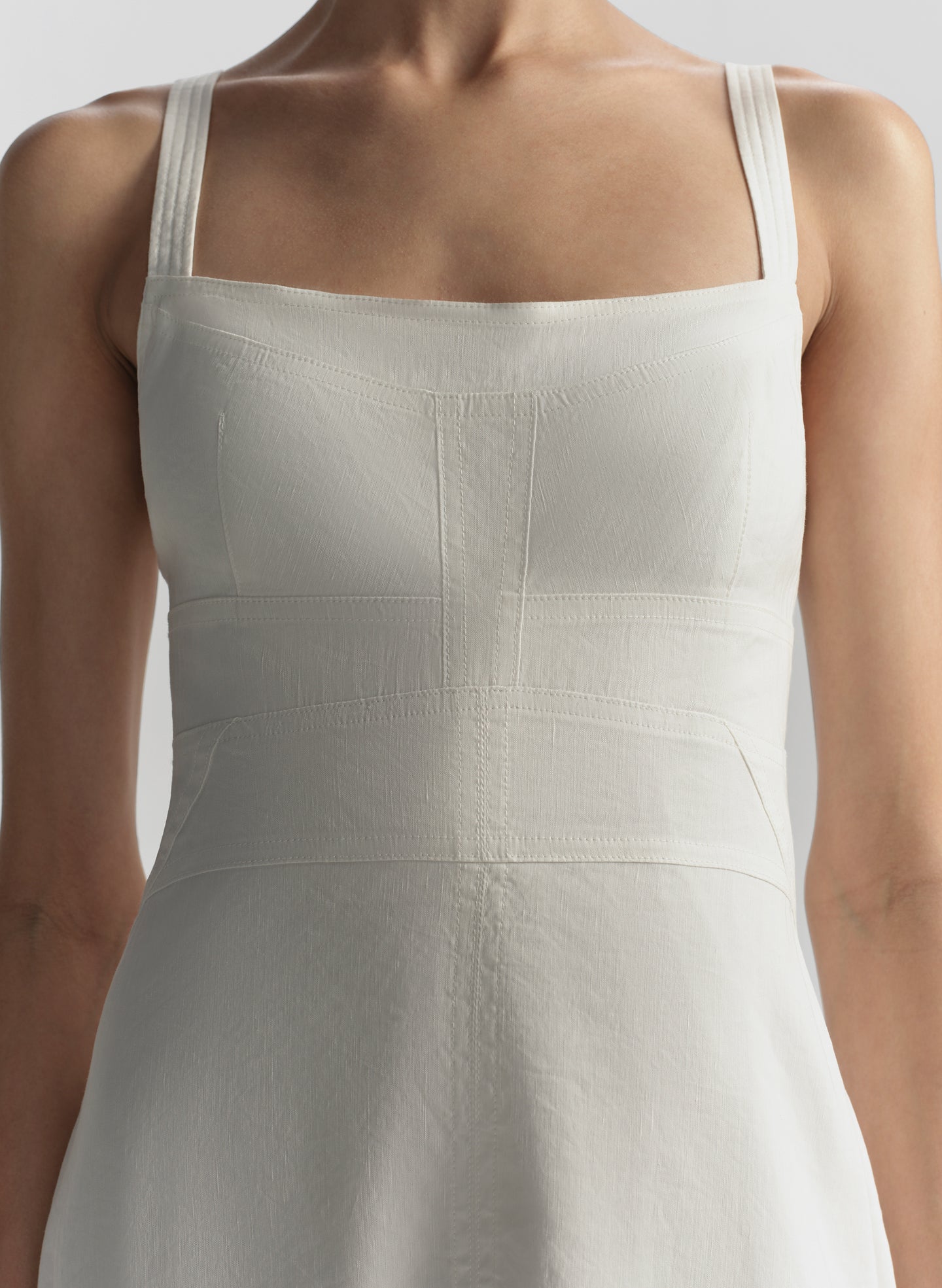 White dress with thin straps on a neutral background