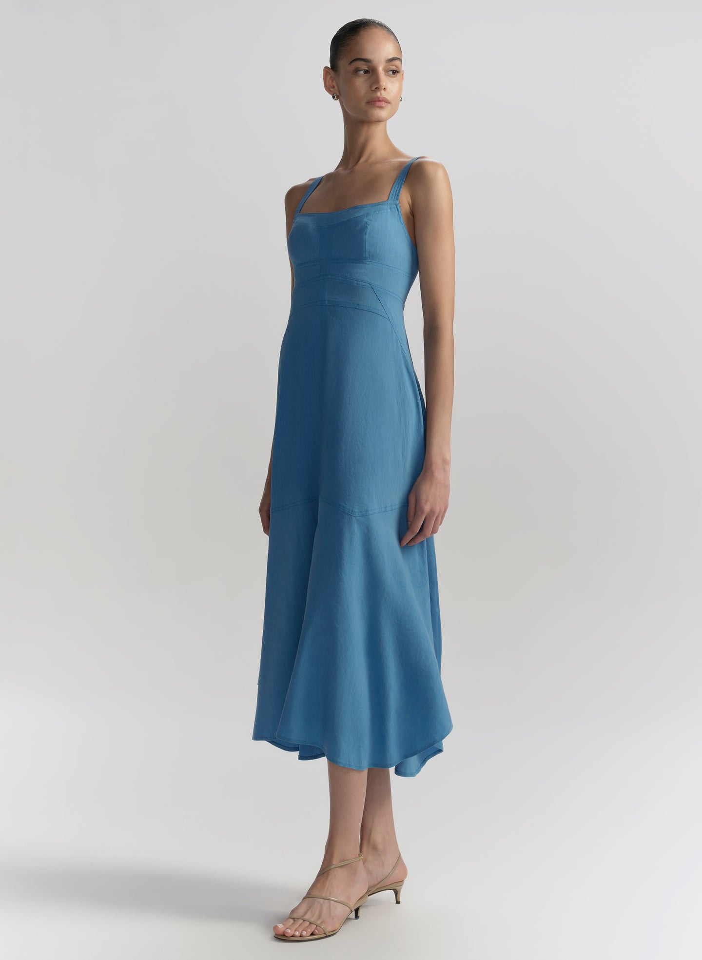 Woman wearing a blue dress against a plain background