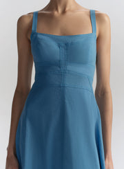 Blue dress worn by a model on a white background