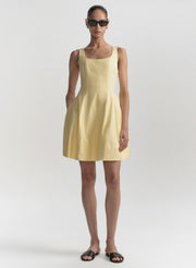 Woman wearing a yellow dress on a white background