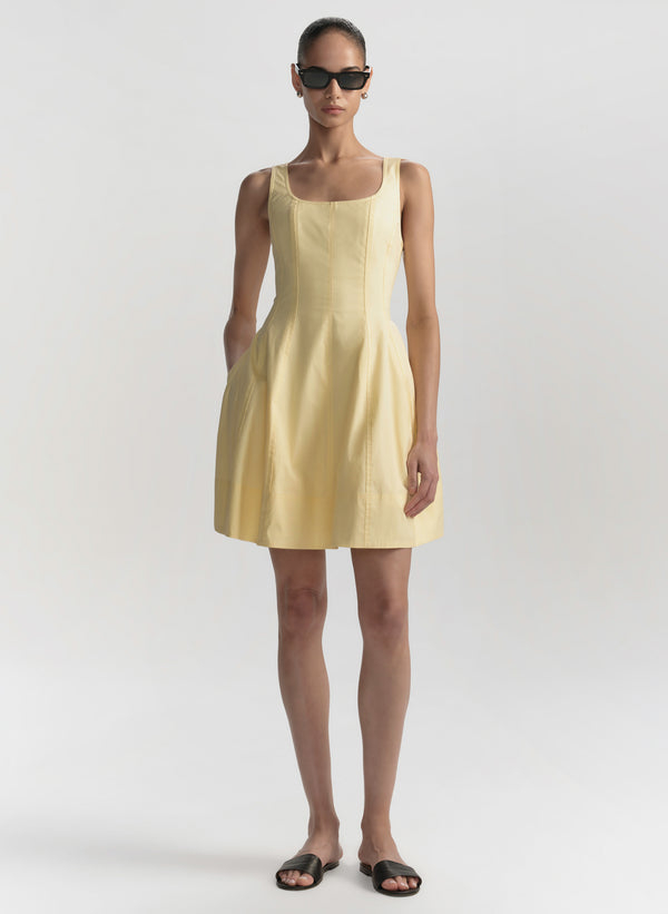Woman wearing a yellow dress on a white background