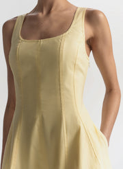 Yellow sleeveless dress on a plain background