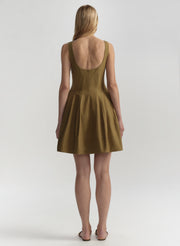 Woman wearing a brown dress with a plain background