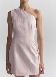 Pink one-shoulder dress worn by a model on a plain background
