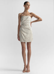 woman wearing white strapless mini dress