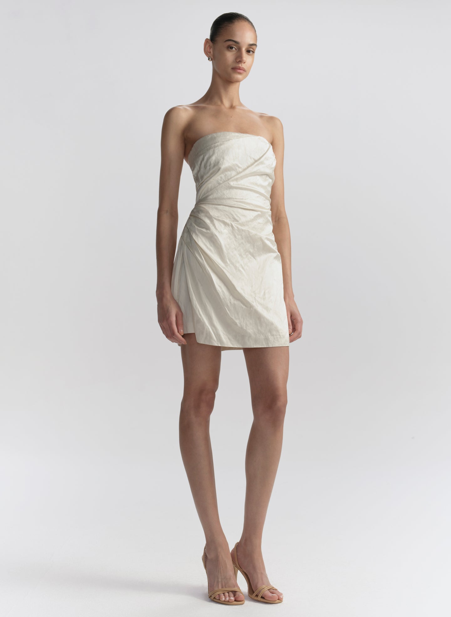 woman wearing white strapless mini dress