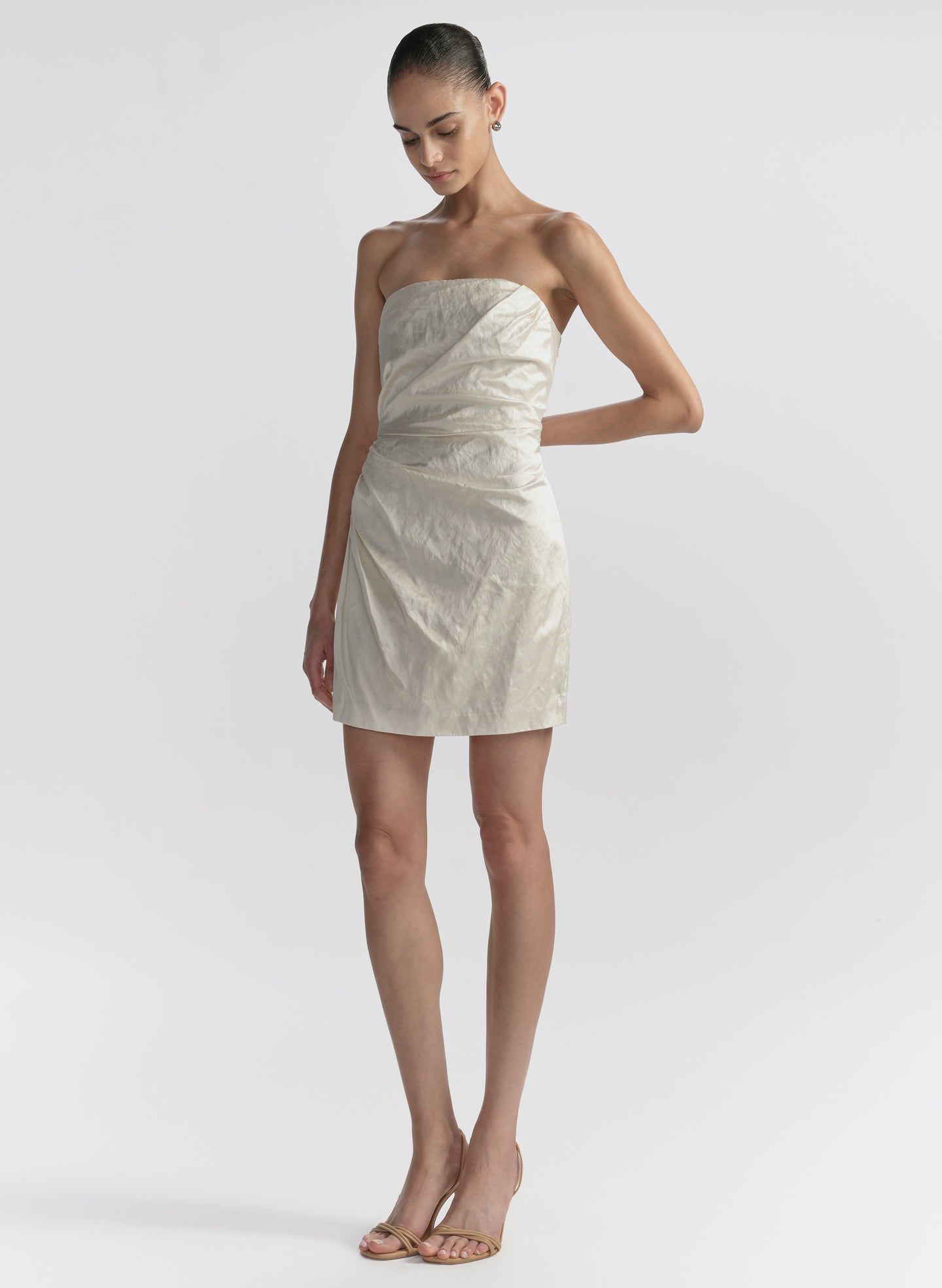 woman wearing white strapless mini dress