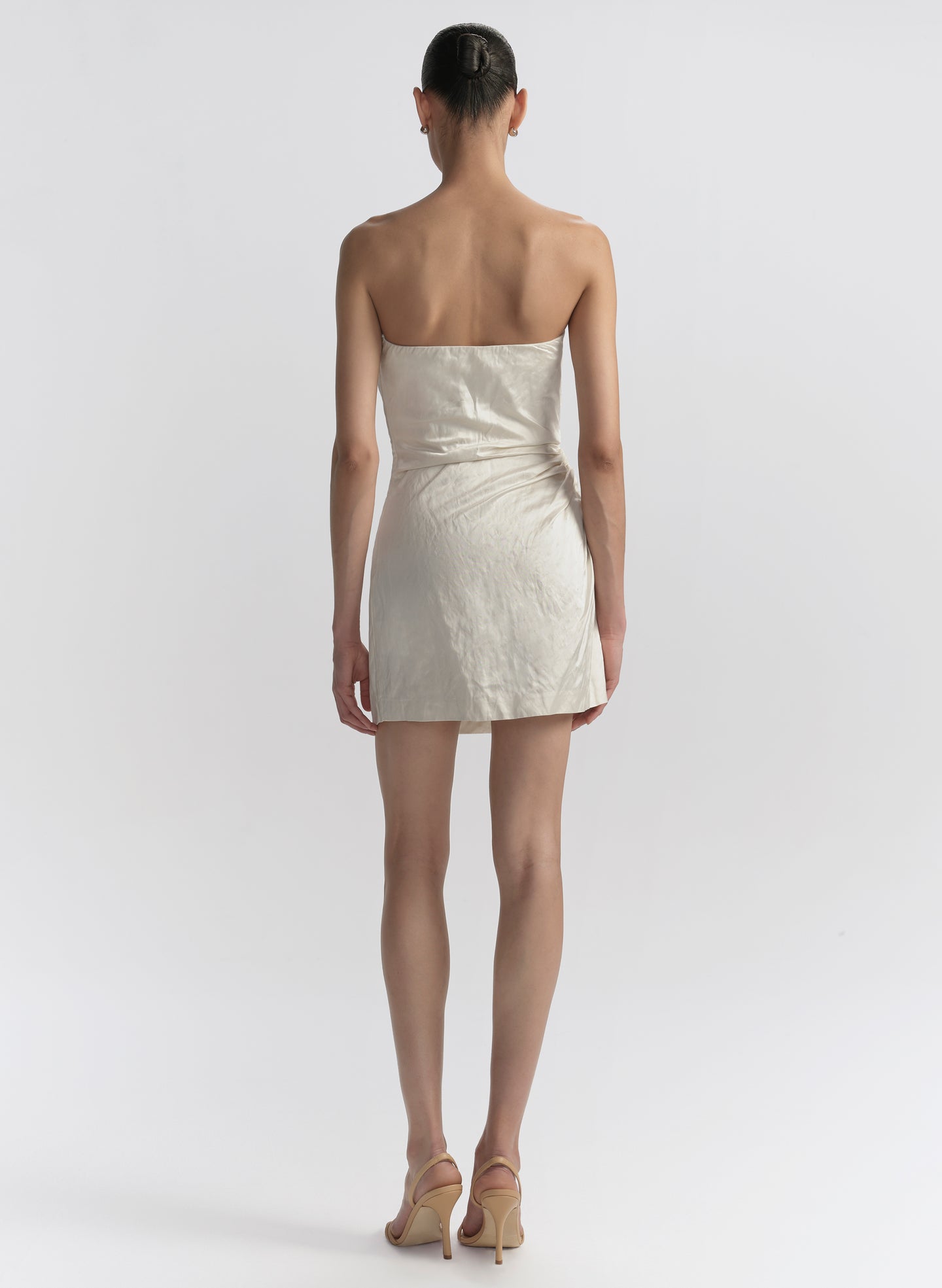 woman wearing white strapless mini dress