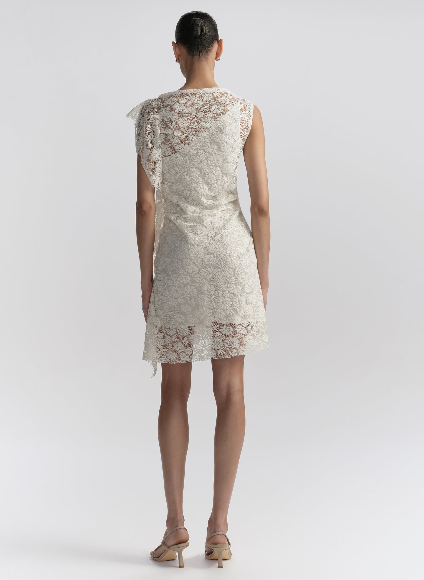 woman wearing white lace mini dress