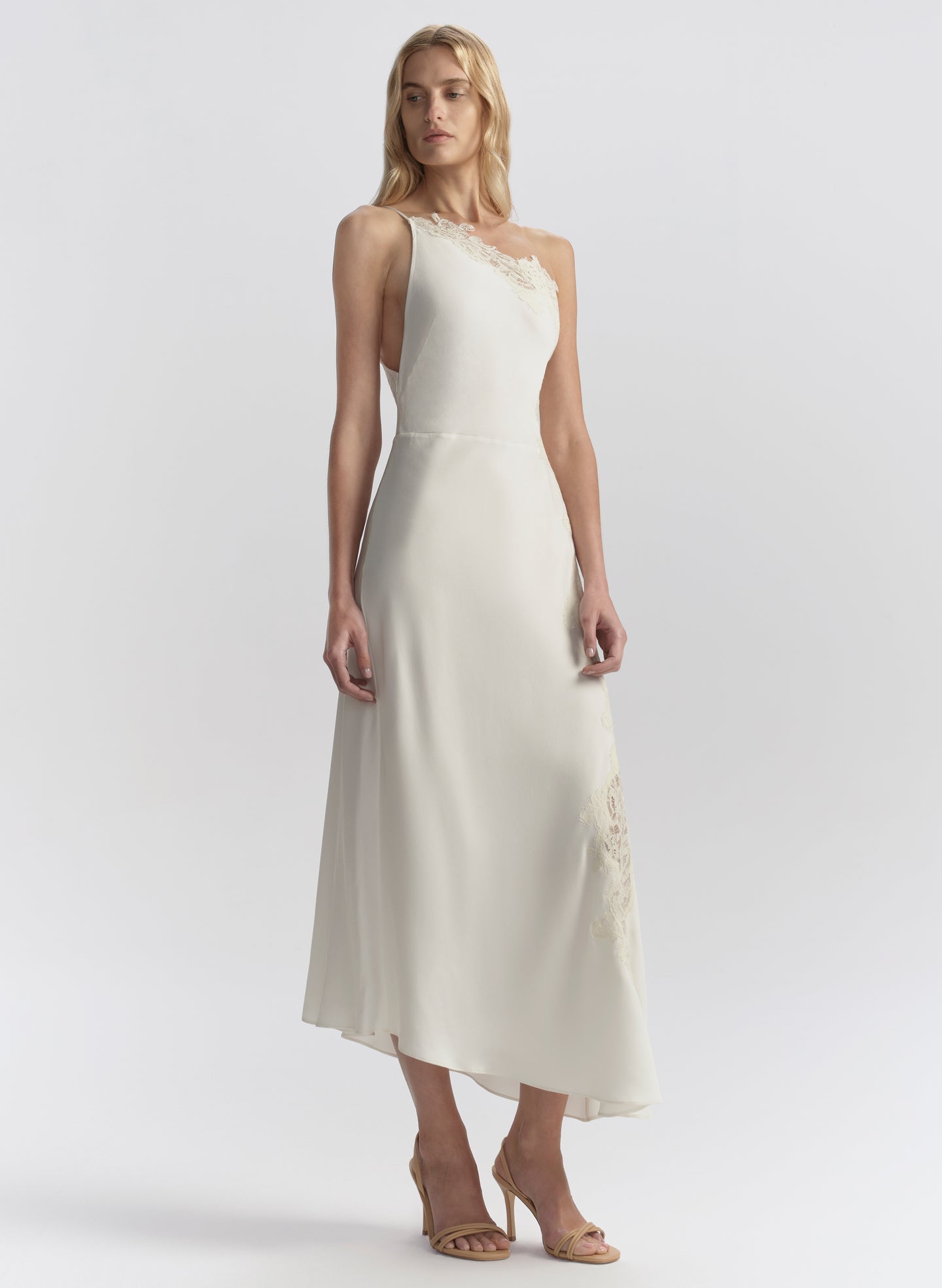 woman wearing white one shoulder lace trim midi dress