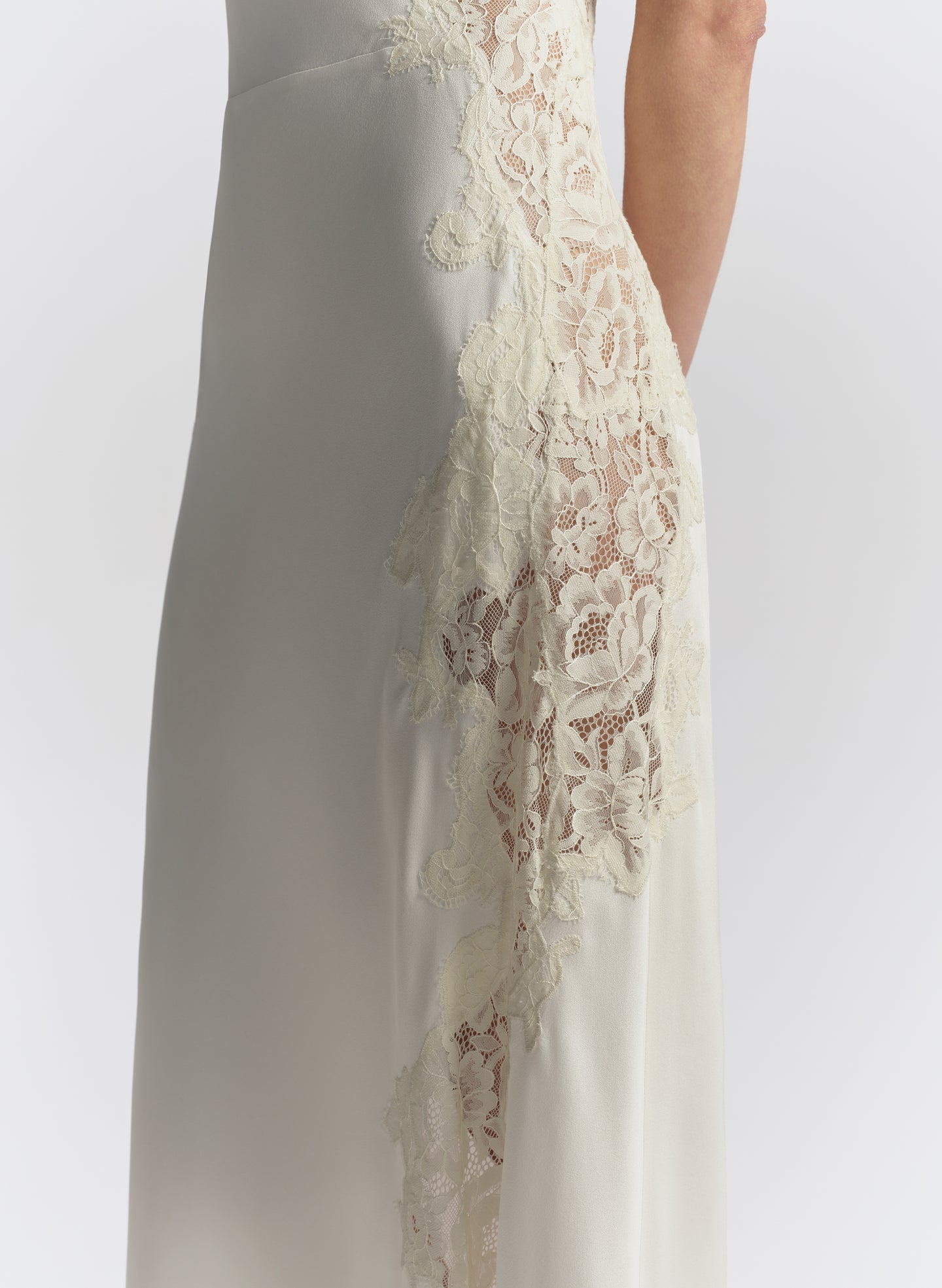 woman wearing white one shoulder lace trim midi dress