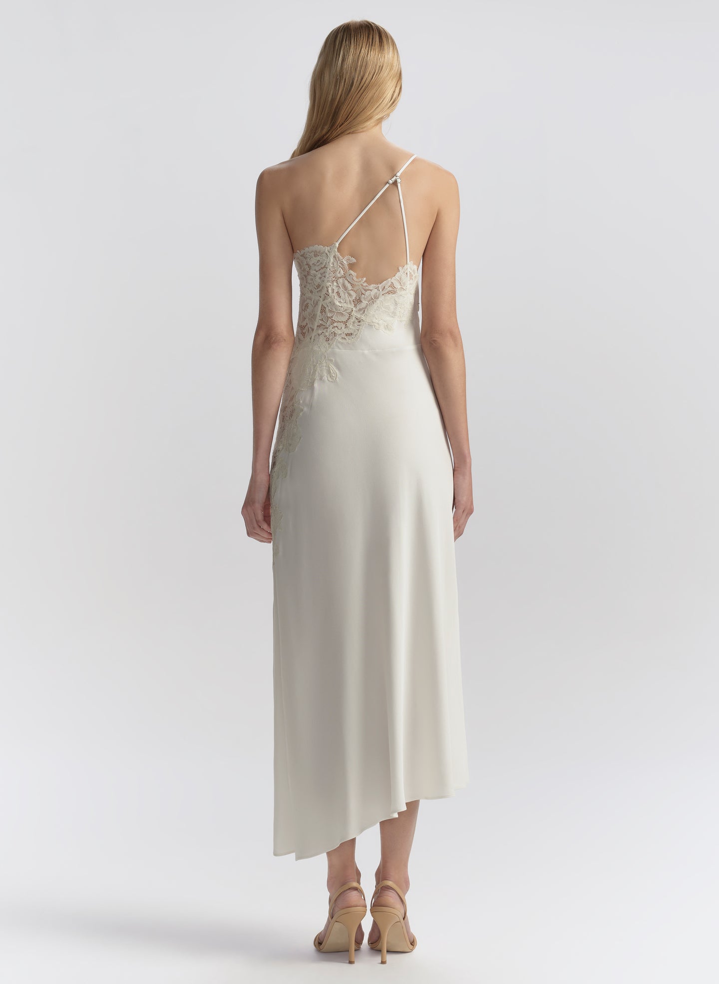 woman wearing white one shoulder lace trim midi dress