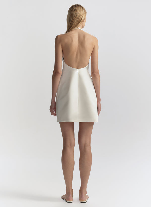 woman wearing white halter mini dress