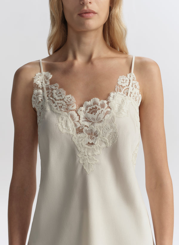 woman wearing white lace trimmed camisole top and matching short