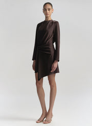 Woman wearing a brown dress on a plain background