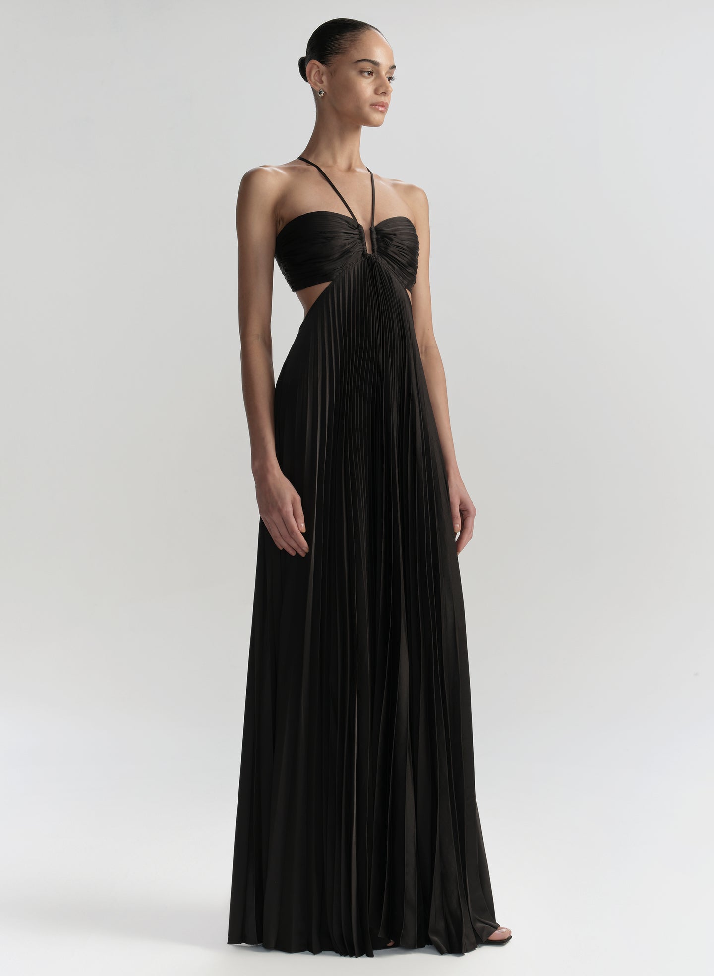 Woman wearing a black evening gown on a white background