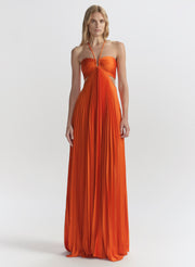 woman wearing orange pleated maxi dress