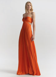 woman wearing orange pleated maxi dress