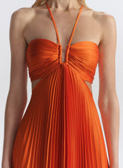 woman wearing orange pleated maxi dress