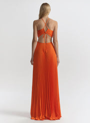 woman wearing orange pleated maxi dress