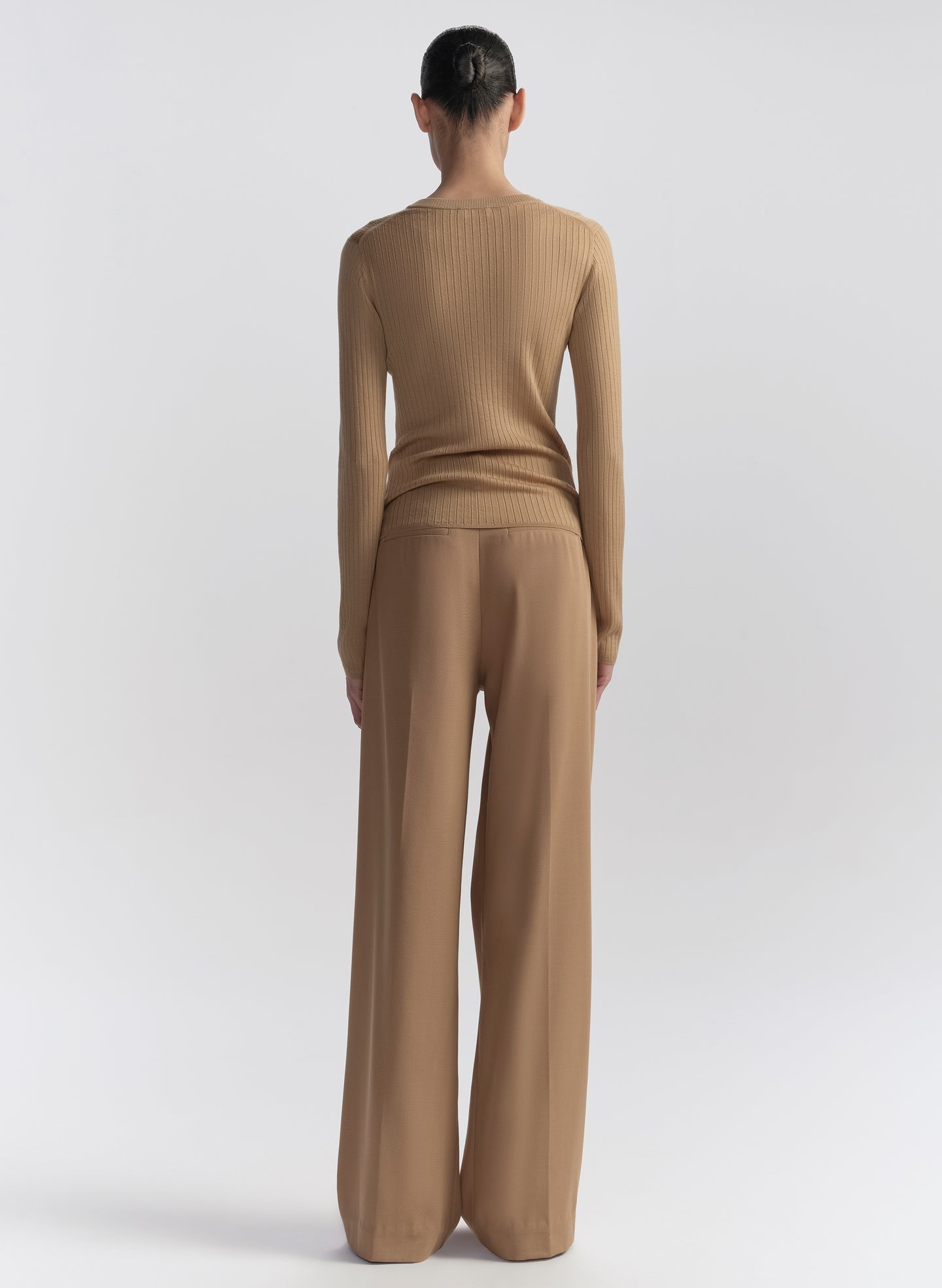 woman wearing tan cardigan and tan pants