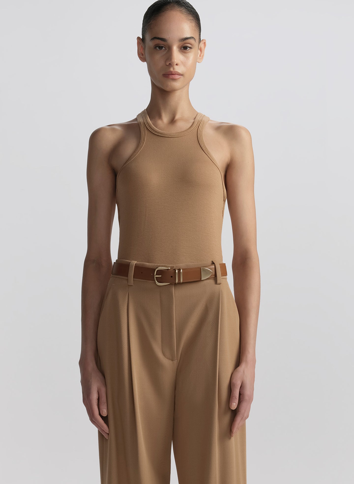 woman wearing tan tank top and matching trousers 