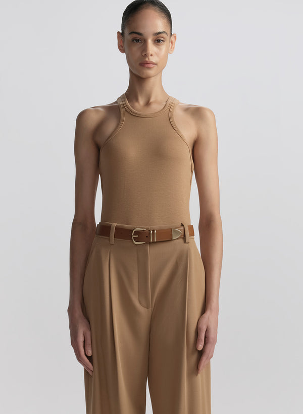 woman wearing tan tank top and matching trousers 