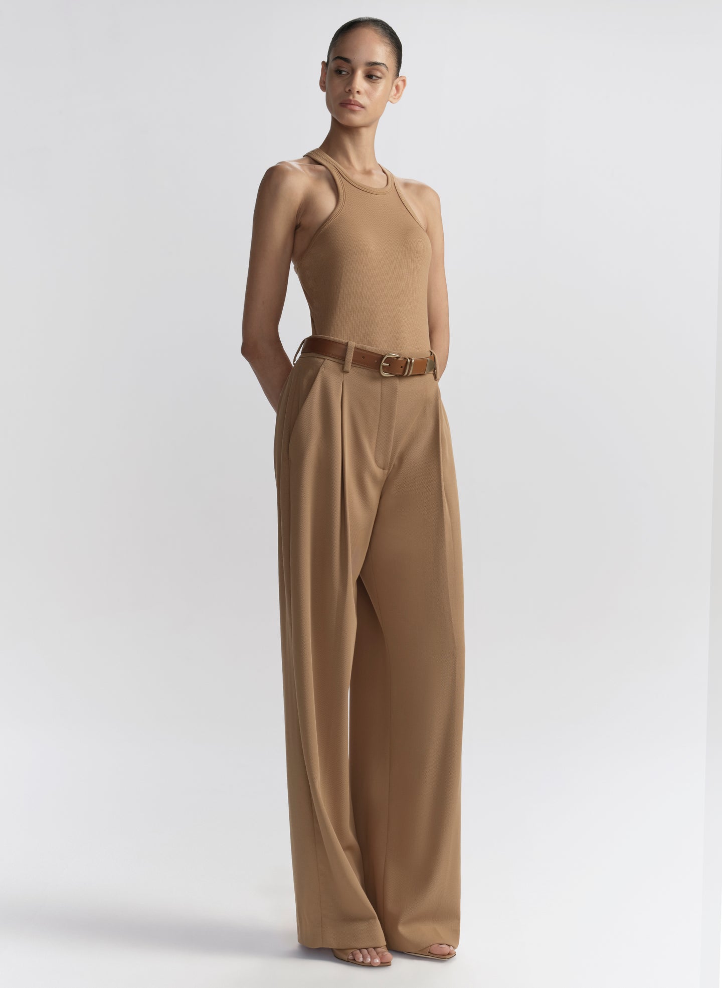 woman wearing tan tank top and matching trousers 