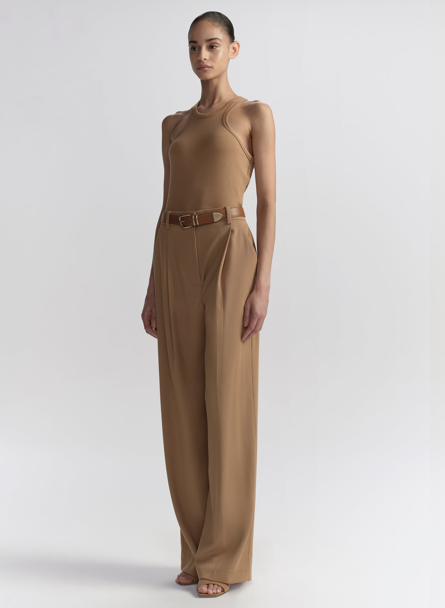 woman wearing tan tank top and matching trousers 