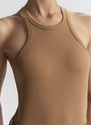 woman wearing tan tank top and matching trousers 