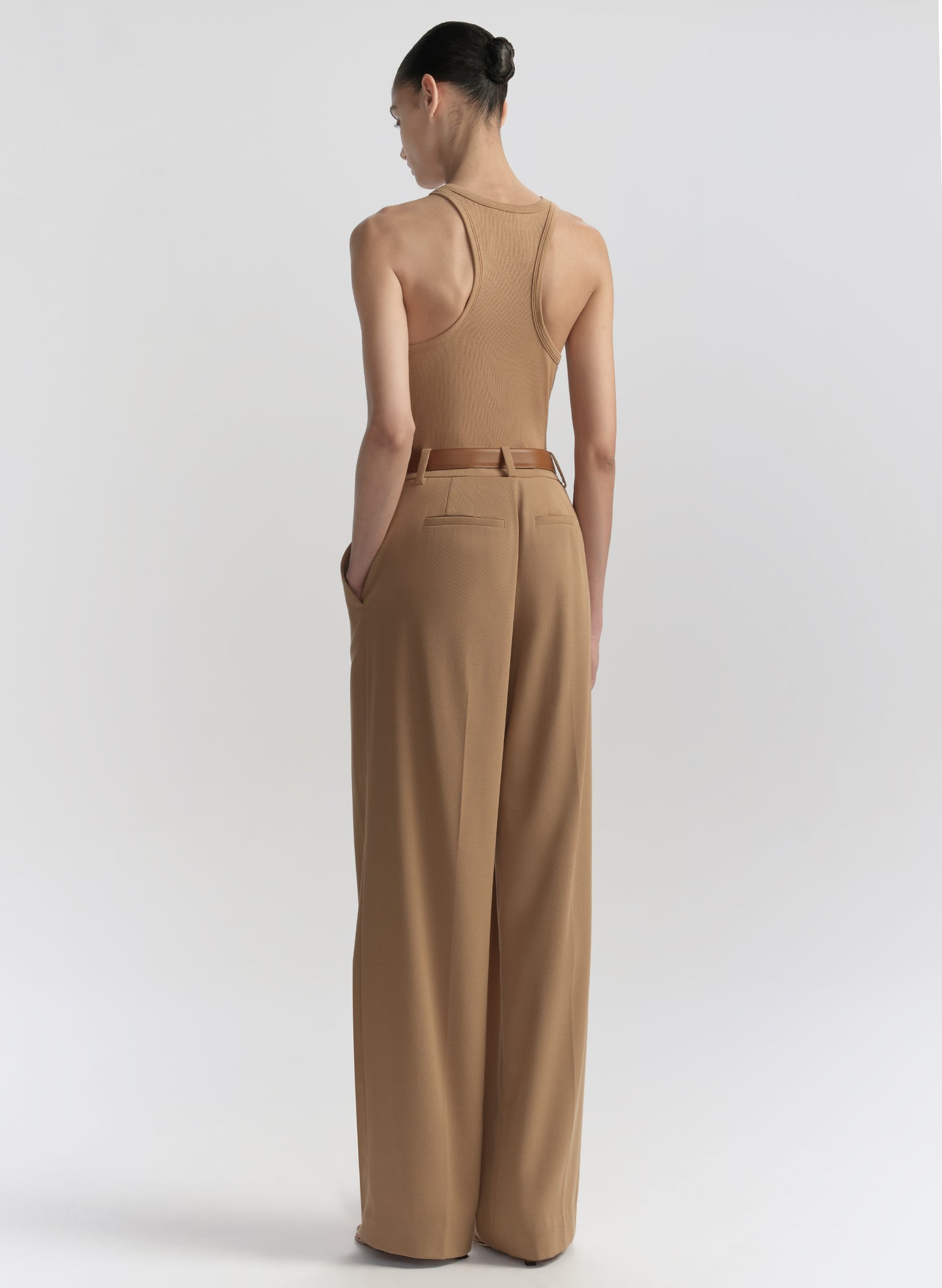 woman wearing tan tank top and matching trousers 