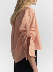 woman wearing orange striped shirt and navy blue pants