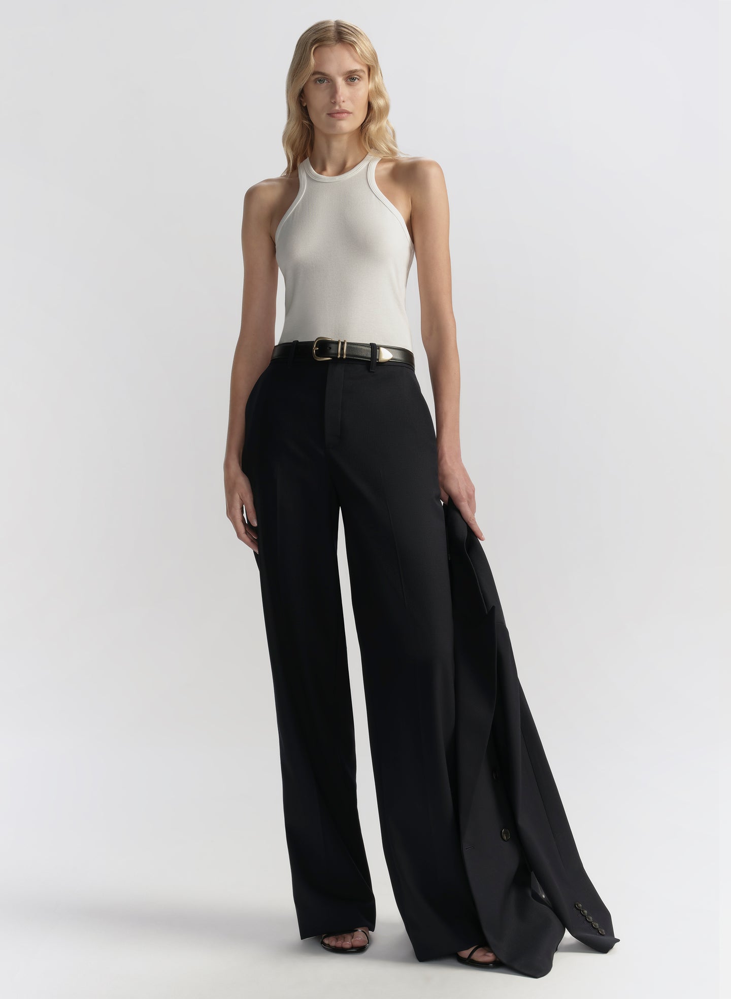 woman wearing white tank top and black pants