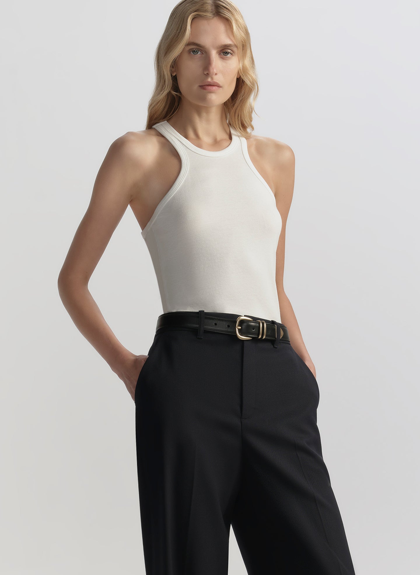 woman wearing white tank top and black pants