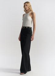 woman wearing white tank top and black pants