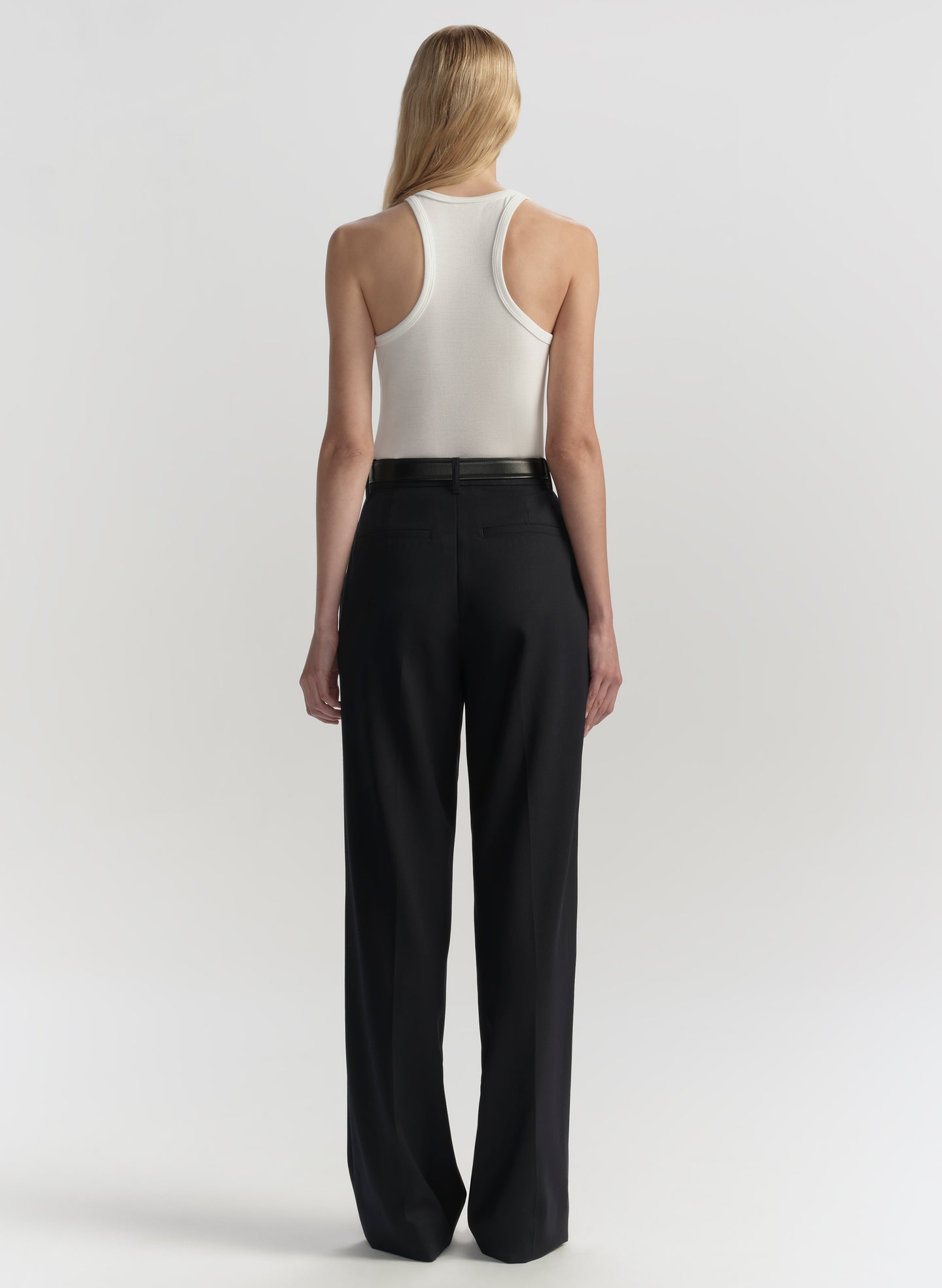 woman wearing white tank top and black pants