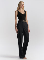 woman wearing black tank top and black pants