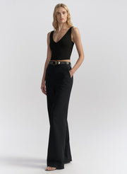 woman wearing black tank top and black pants