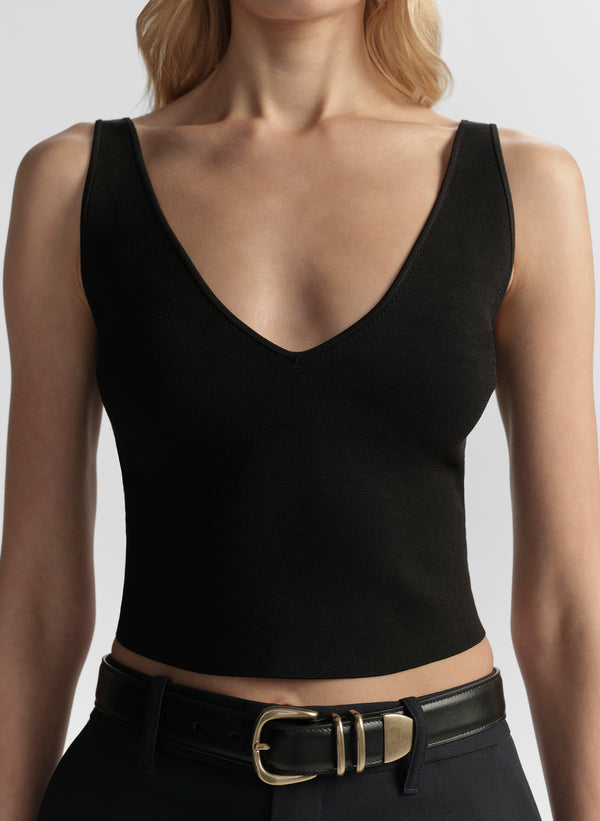 woman wearing black tank top and black pants