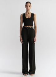 woman wearing black tank top and black pants