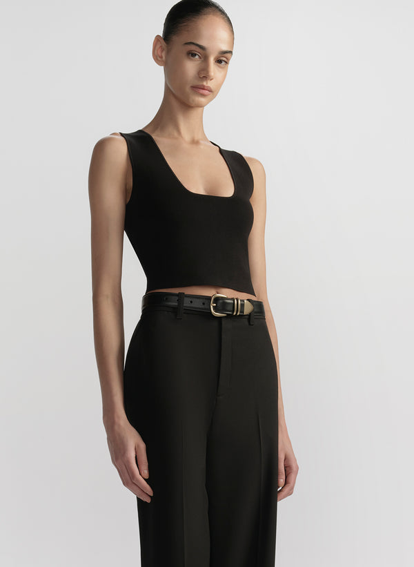 woman wearing black tank top and black pants