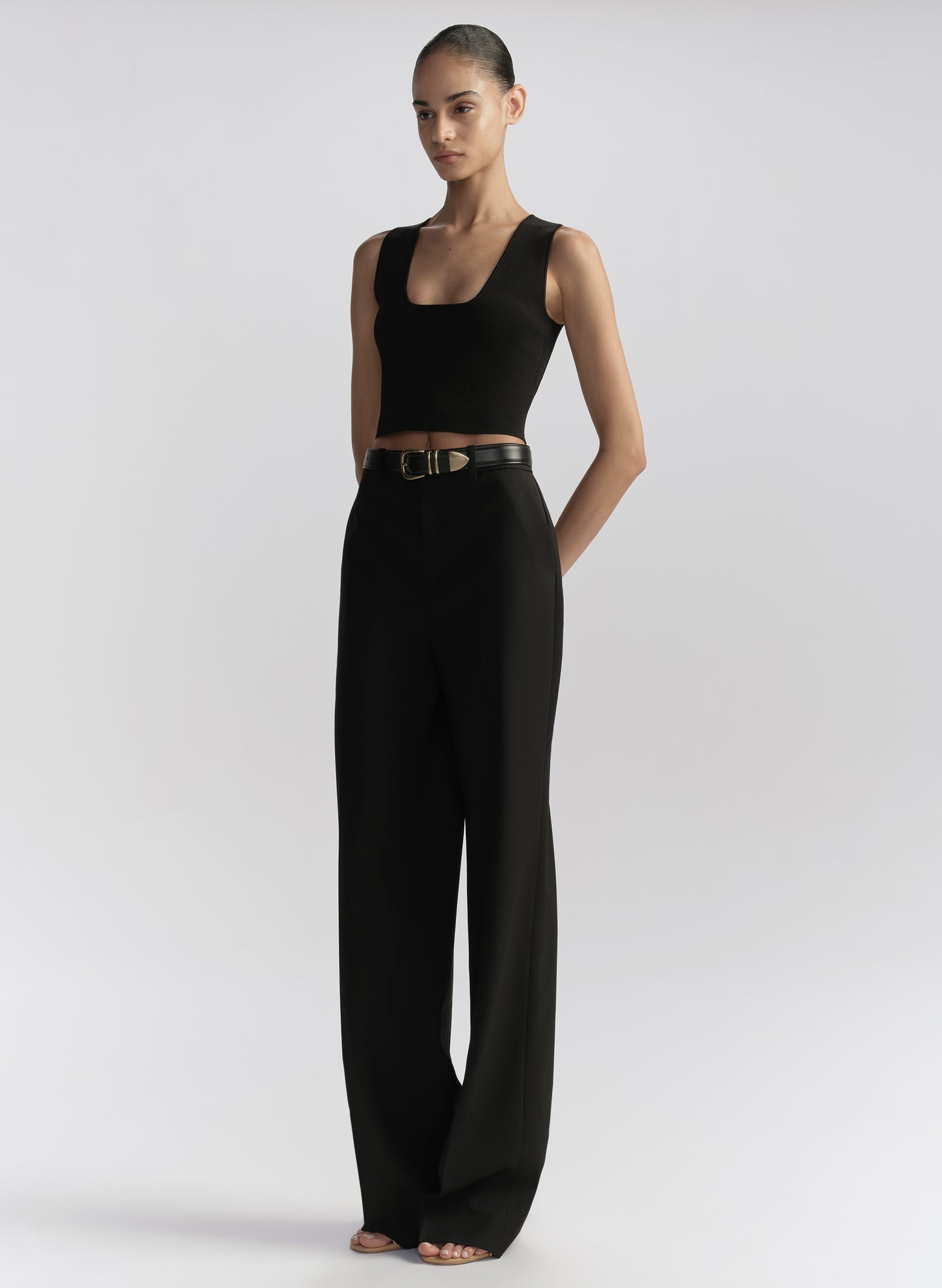 woman wearing black tank top and black pants