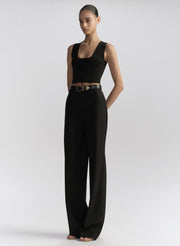 woman wearing black tank top and black pants