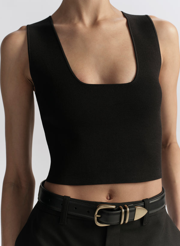 woman wearing black tank top and black pants