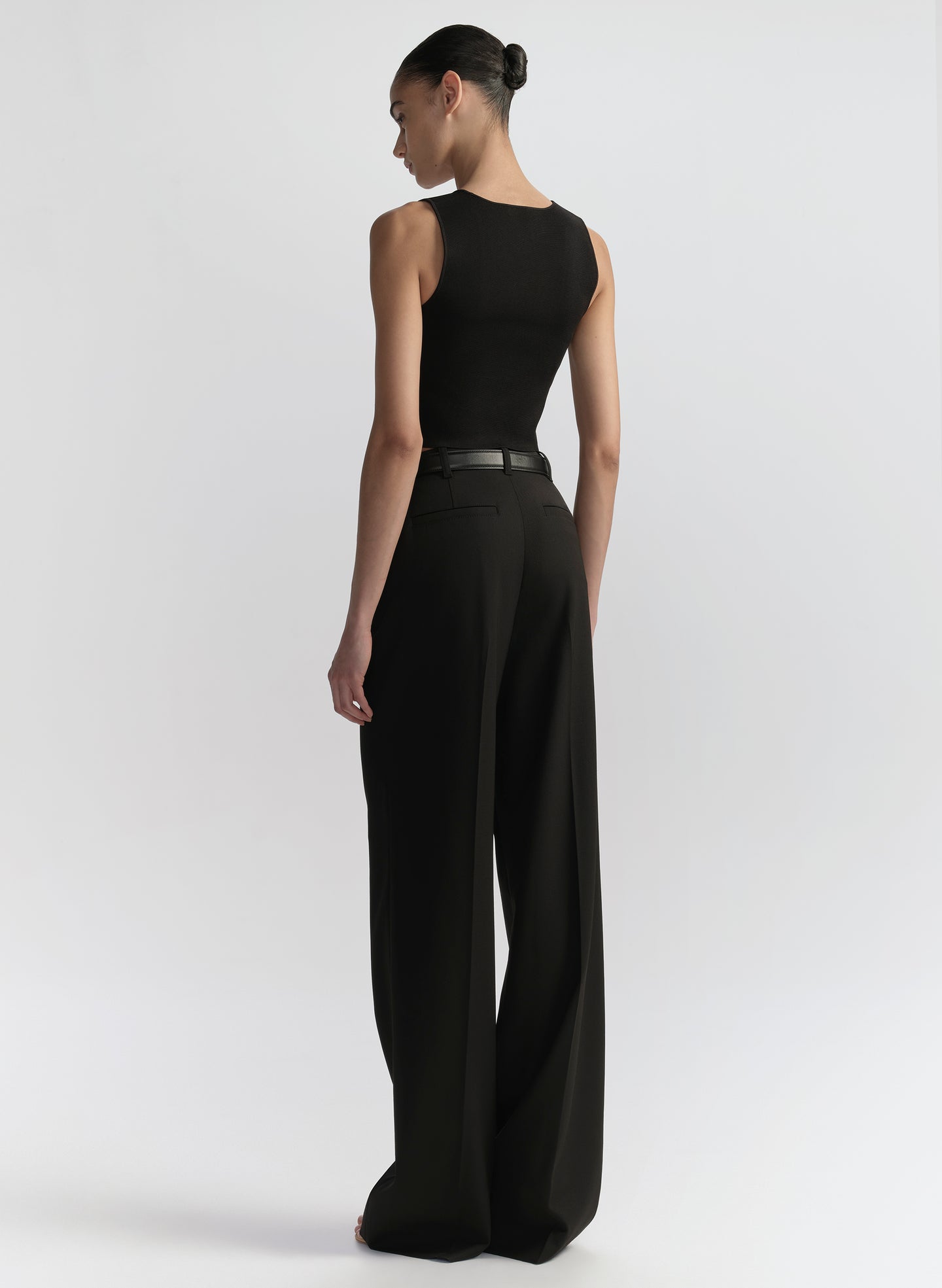 woman wearing black tank top and black pants