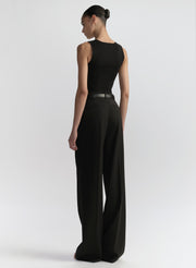 woman wearing black tank top and black pants