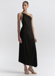 Woman wearing a black one-shoulder dress on a white background